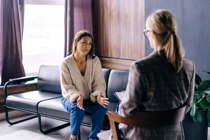 A young woman in a consultation with a professional psychologist talks about her problems